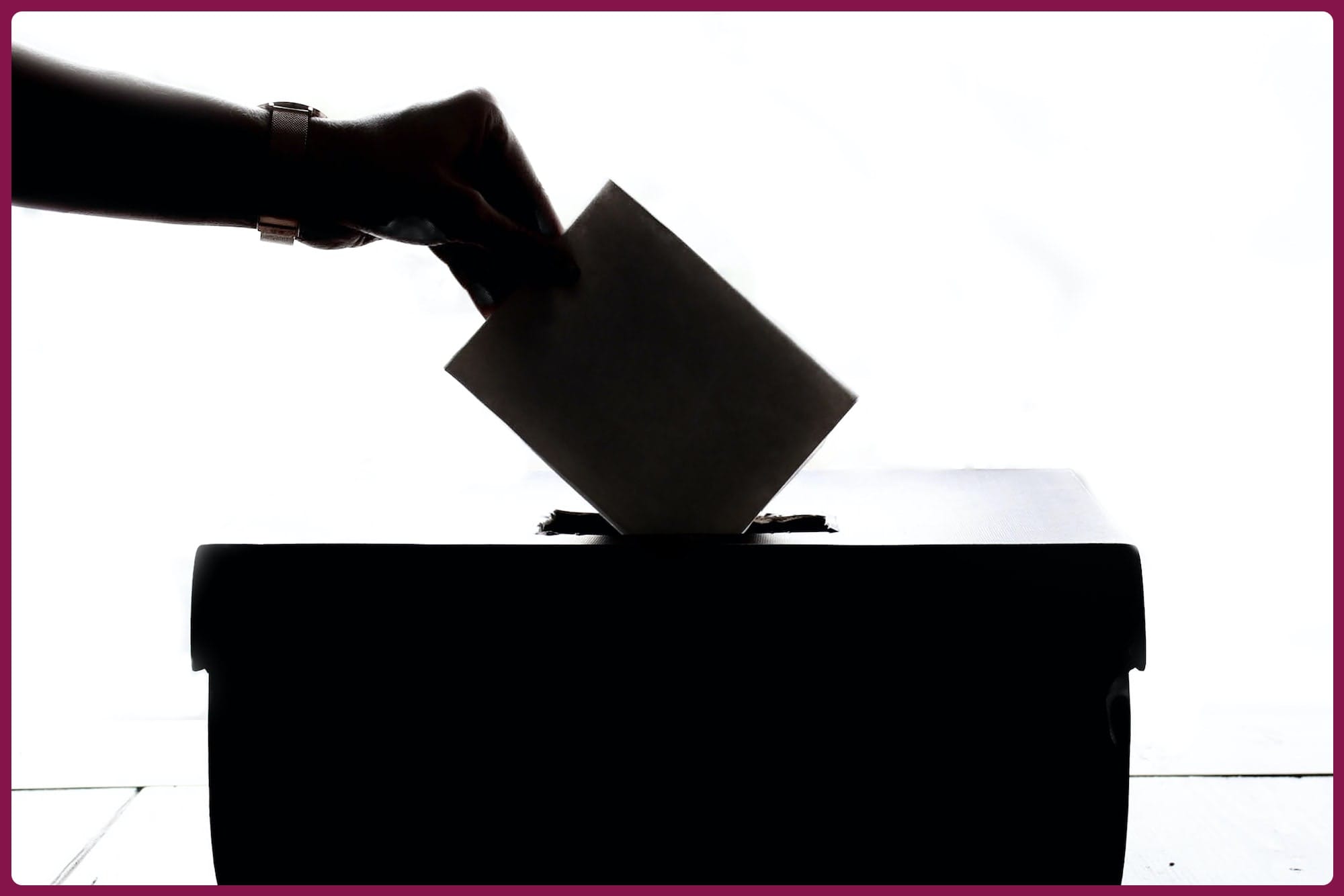 a person is casting a vote into a box